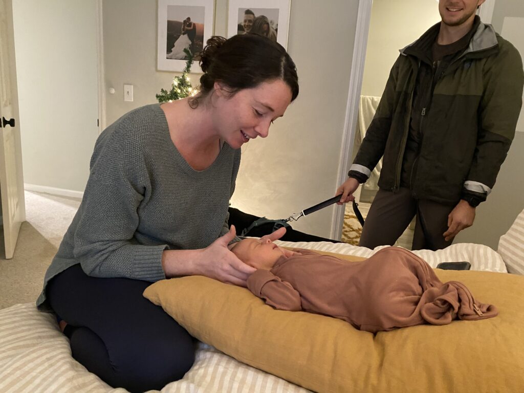 Morgan Simpson with Atlanta Christian Doula performing gentle chiropractic adjustments in-home on newborn baby