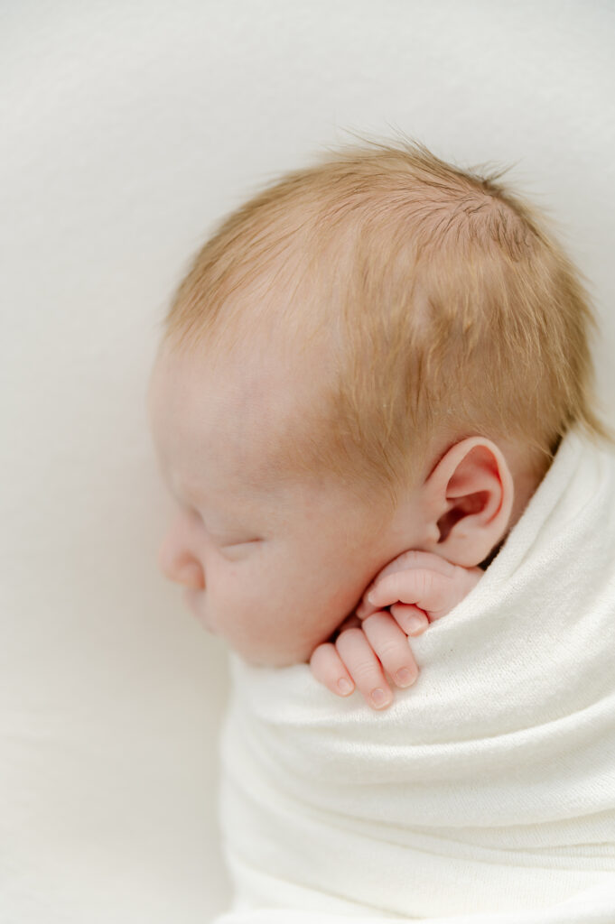 Posed sleeping newborn baby at in-home newborn photoshoot in Roswell, GA